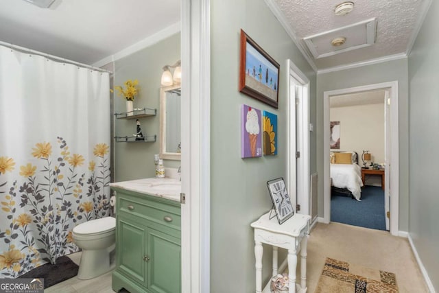 bathroom featuring a textured ceiling, toilet, ornamental molding, and vanity