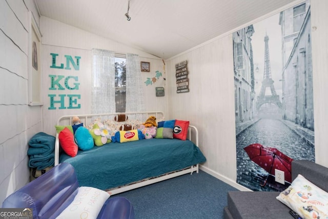 bedroom with carpet floors and vaulted ceiling