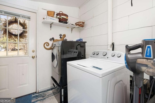 clothes washing area featuring washer / dryer