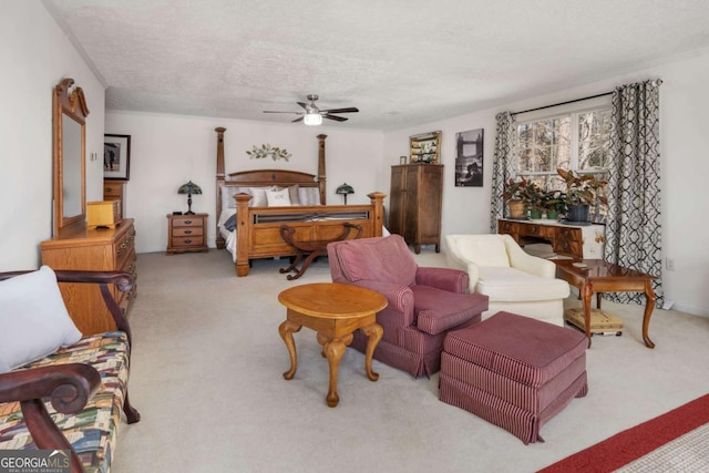 bedroom featuring a textured ceiling, ceiling fan, and light colored carpet