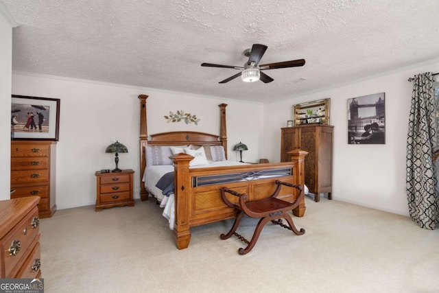 bedroom featuring ceiling fan, light colored carpet, ornamental molding, and a textured ceiling