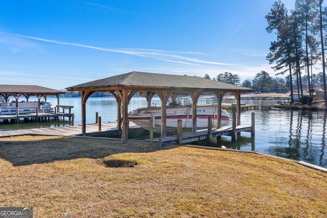 dock area with a water view and a yard