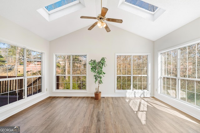 unfurnished sunroom with ceiling fan, lofted ceiling, and a healthy amount of sunlight