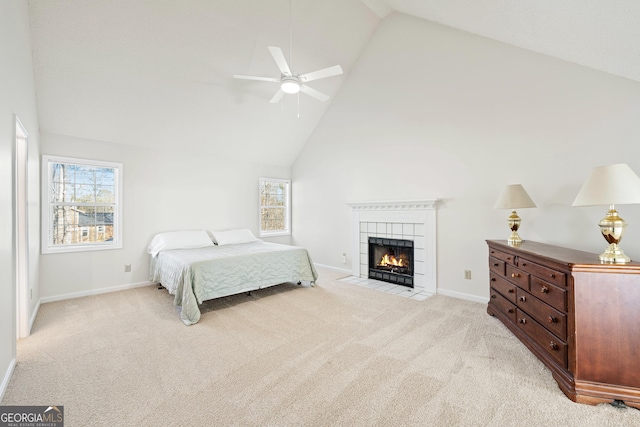 bedroom featuring ceiling fan, light colored carpet, multiple windows, and high vaulted ceiling