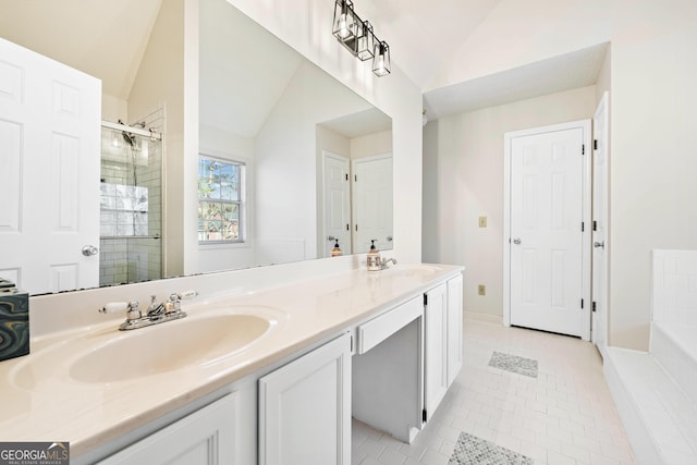 bathroom with a shower with shower door, vanity, vaulted ceiling, and tile patterned floors