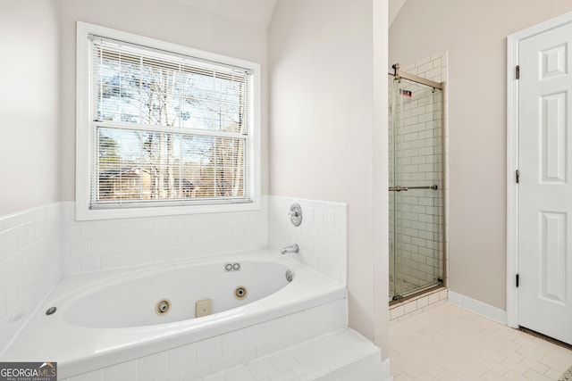 bathroom featuring lofted ceiling, a wealth of natural light, shower with separate bathtub, and tile patterned floors