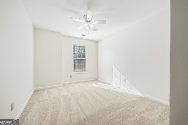 spare room featuring ceiling fan and light colored carpet