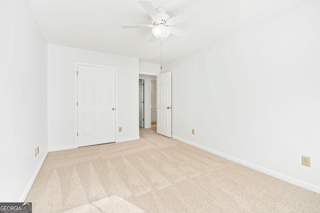 unfurnished bedroom featuring ceiling fan and light carpet