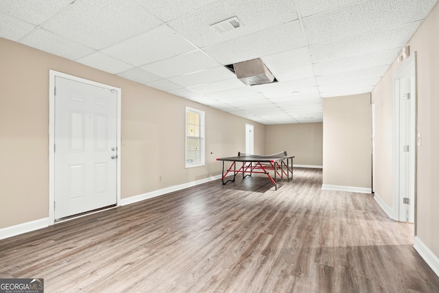 playroom with hardwood / wood-style floors and a drop ceiling