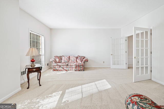 living room featuring light colored carpet and french doors