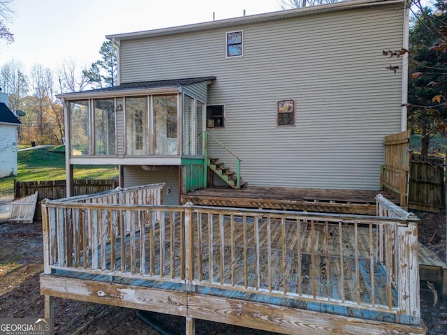 rear view of house featuring a deck and a sunroom