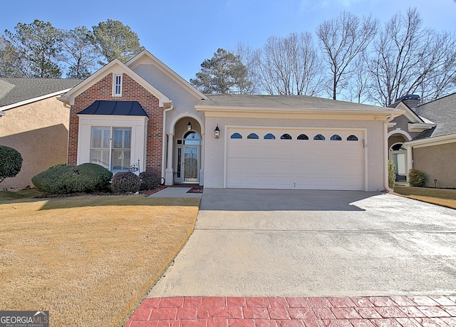 view of front of home with a garage and a front lawn