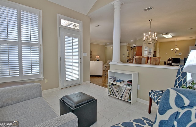 living room with ornate columns, light tile patterned flooring, vaulted ceiling, and a notable chandelier