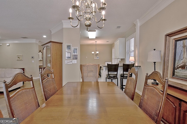 dining area featuring crown molding, a notable chandelier, and a textured ceiling