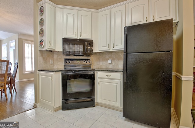 kitchen with white cabinets, dark stone counters, decorative backsplash, and black appliances