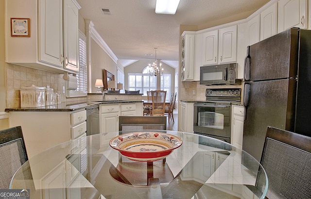 kitchen featuring white cabinetry, an inviting chandelier, decorative light fixtures, kitchen peninsula, and black appliances