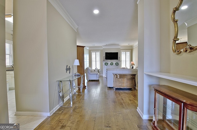 hall featuring crown molding and light hardwood / wood-style flooring