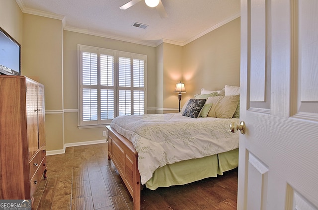 bedroom with dark hardwood / wood-style flooring, crown molding, and ceiling fan