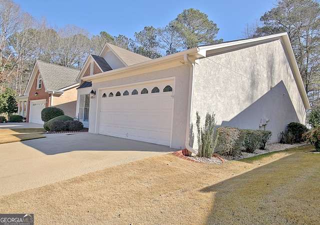 view of home's exterior featuring a garage and a lawn