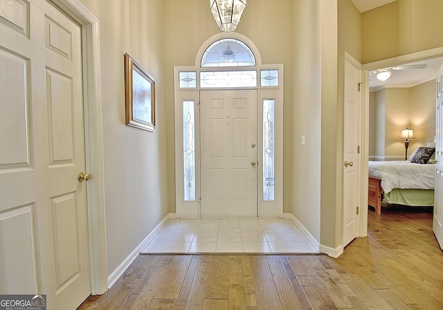 entryway with a towering ceiling and light hardwood / wood-style floors