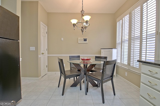 dining room featuring light tile patterned floors and a chandelier