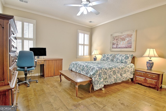 bedroom with crown molding, ceiling fan, light hardwood / wood-style floors, and a textured ceiling