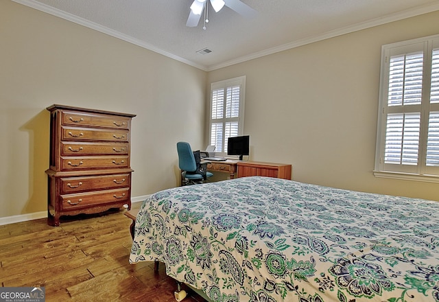 bedroom with crown molding, ceiling fan, and light wood-type flooring