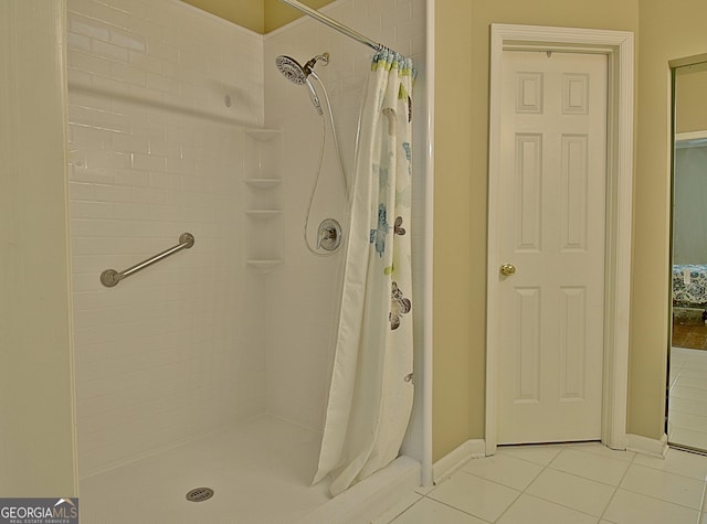 bathroom with a shower with curtain and tile patterned flooring