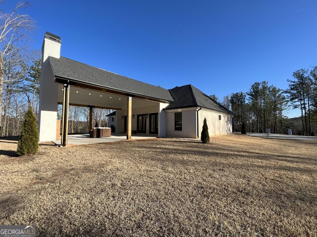 back of house with a patio area