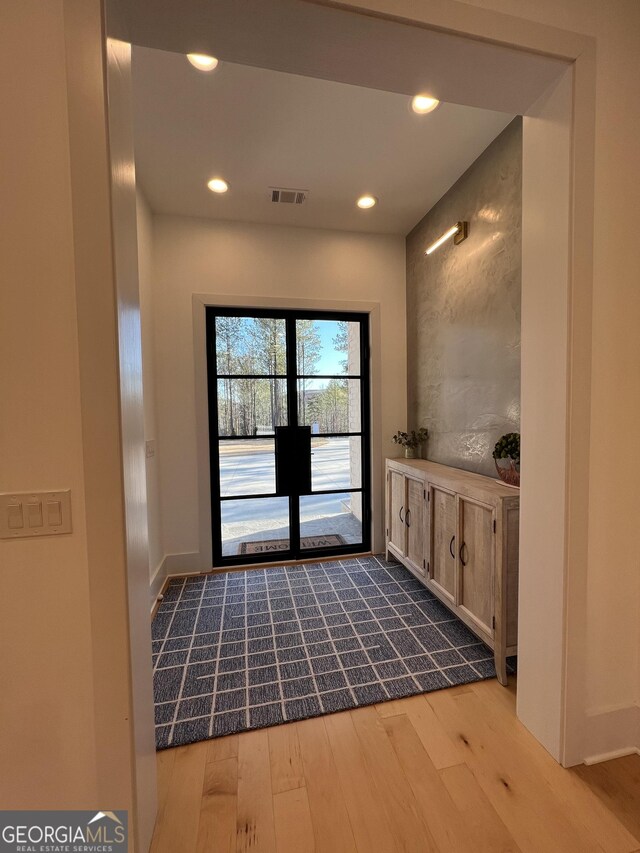 entryway with hardwood / wood-style floors