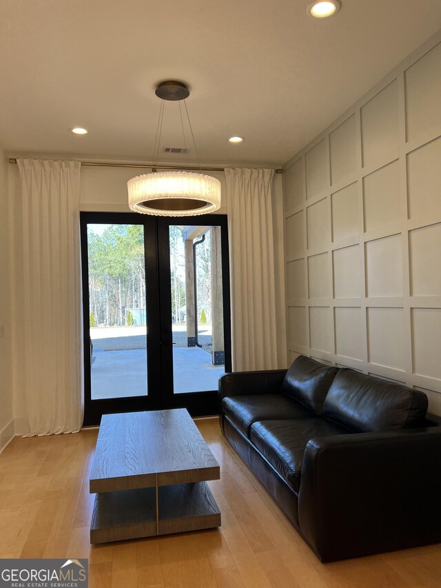 living room with light wood-type flooring and french doors