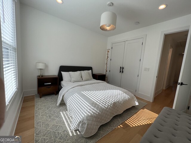 bedroom with a closet and light hardwood / wood-style floors