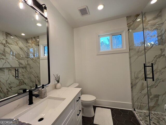 bathroom with tile patterned floors, an enclosed shower, vanity, and a healthy amount of sunlight