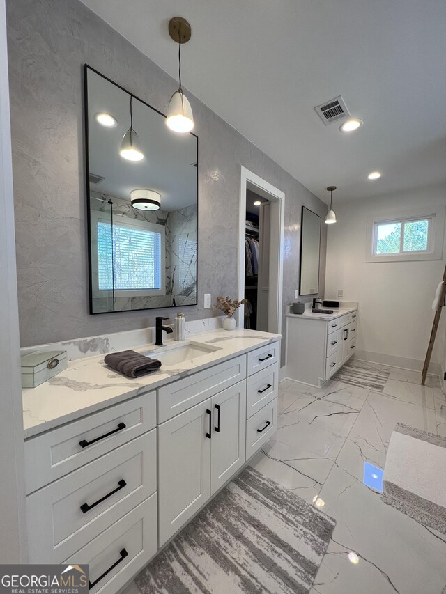 bathroom featuring a shower and vanity