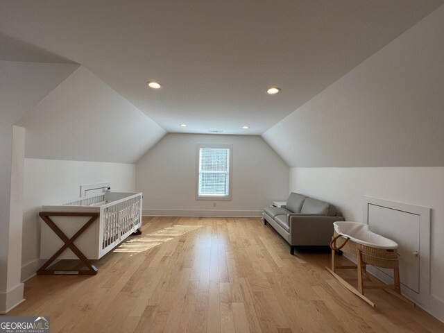 bonus room with lofted ceiling and light hardwood / wood-style flooring