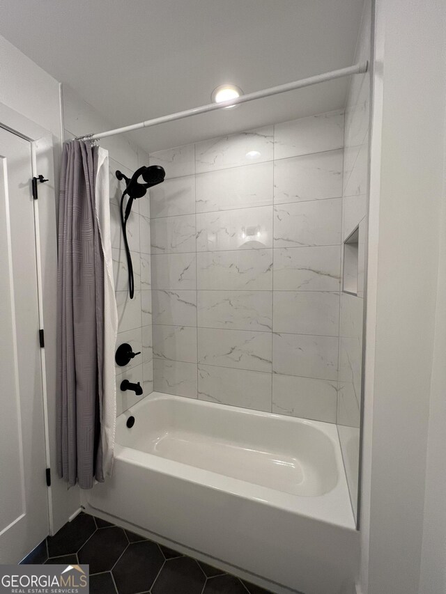 bathroom with tile patterned floors and shower / bath combo with shower curtain