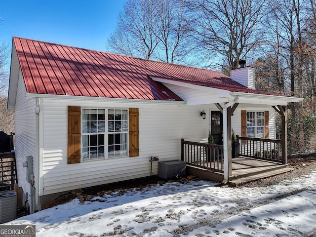 view of front of home with a porch and cooling unit