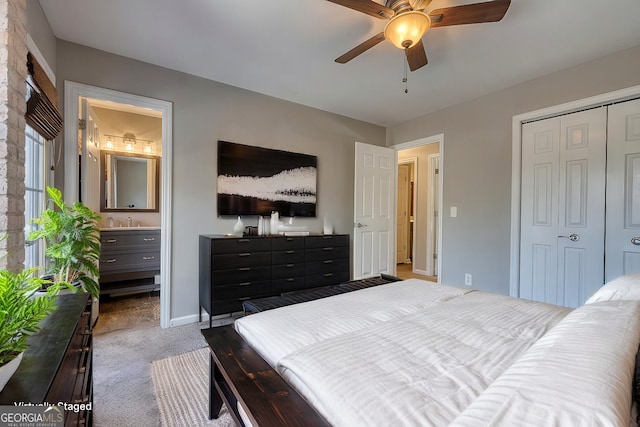 bedroom featuring sink, ensuite bath, ceiling fan, light carpet, and a closet