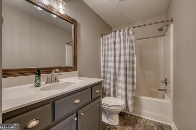 full bathroom featuring vanity, shower / tub combo, a textured ceiling, and toilet