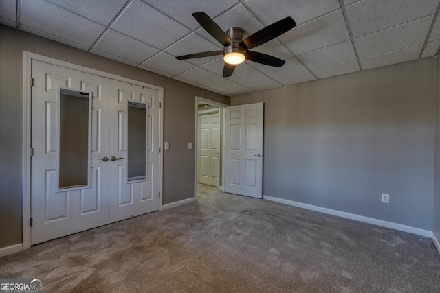 unfurnished bedroom featuring a closet, ceiling fan, and carpet