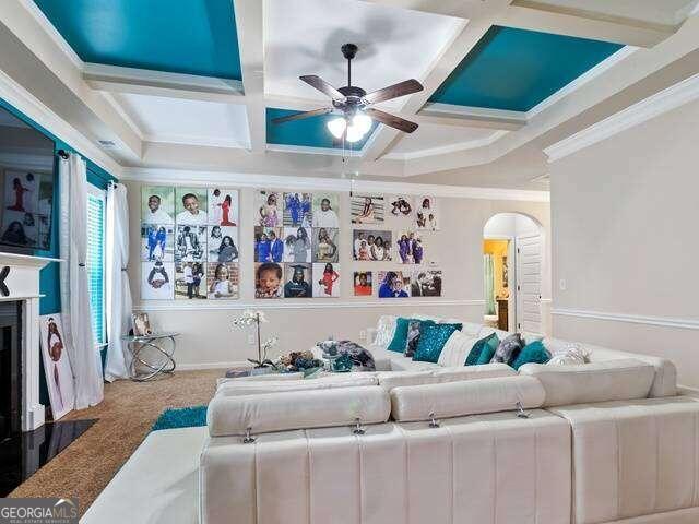 carpeted living room with ornamental molding, coffered ceiling, and beamed ceiling