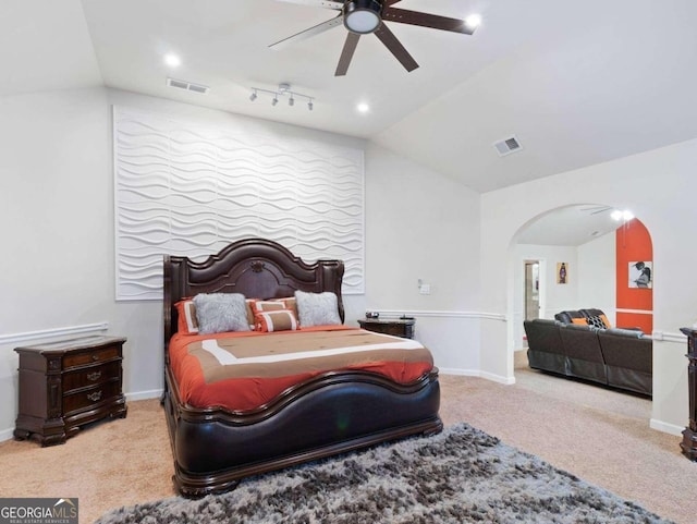 carpeted bedroom featuring ceiling fan and vaulted ceiling