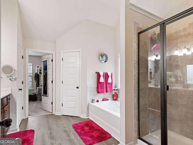 bathroom with shower with separate bathtub, hardwood / wood-style flooring, and vanity