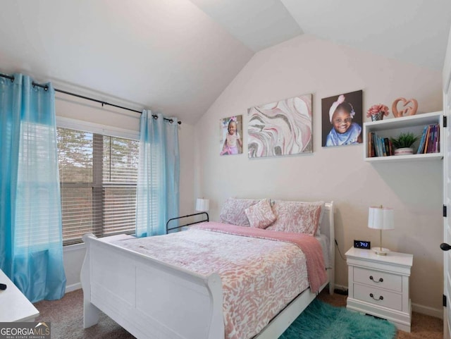 bedroom featuring lofted ceiling and dark carpet