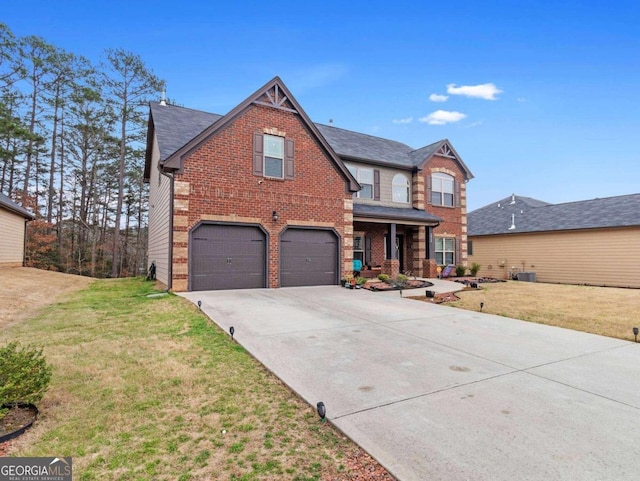 view of front of property featuring a front yard, central AC, and a garage