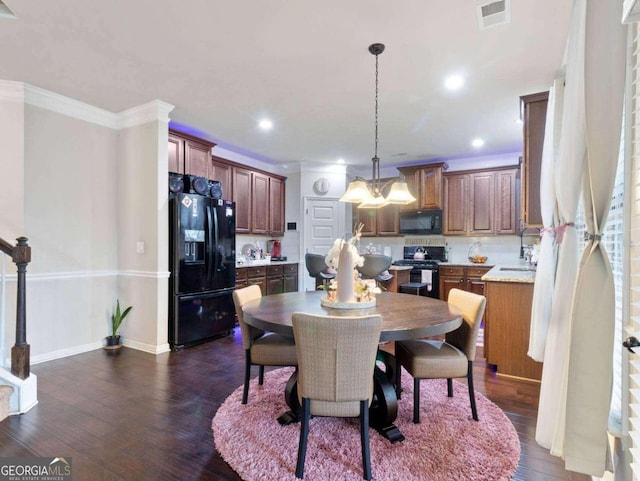 dining space featuring dark hardwood / wood-style flooring and crown molding