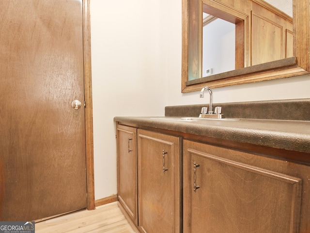 bathroom featuring hardwood / wood-style floors and vanity