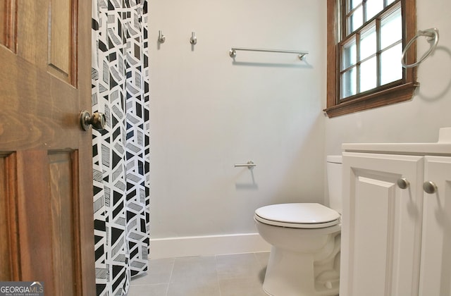 bathroom with toilet, tile patterned flooring, and vanity