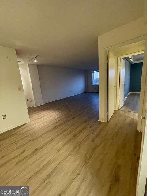 bonus room with wood-type flooring