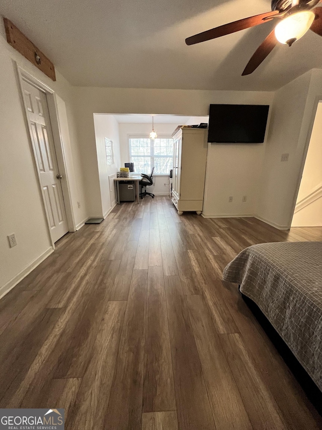 bedroom featuring ceiling fan and dark hardwood / wood-style flooring